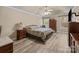 Main bedroom features wood-look floors, a ceiling fan, and two windows at 11542 Laurel View Dr, Charlotte, NC 28273