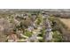 Aerial view featuring neighborhood with tree-lined streets and well-maintained homes with lush green lawns at 11542 Laurel View Dr, Charlotte, NC 28273