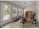 Bright sun room with lots of windows and a door that leads to the back yard at 11542 Laurel View Dr, Charlotte, NC 28273
