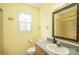 Bright bathroom featuring a vanity, sink, and a framed mirror at 1228 Hidden Creek Cir, Hickory, NC 28602