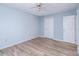This bedroom features light blue walls, hardwood floors, and a ceiling fan at 1228 Hidden Creek Cir, Hickory, NC 28602