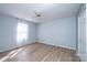 Cozy bedroom with a ceiling fan, hardwood floors, and light blue walls at 1228 Hidden Creek Cir, Hickory, NC 28602