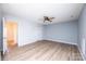 Spacious bedroom with wood floors, fan, and doorway to hall at 1228 Hidden Creek Cir, Hickory, NC 28602