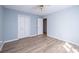 Bright bedroom with light blue walls, wood floor, double closet and fan at 1228 Hidden Creek Cir, Hickory, NC 28602