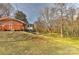 A lovely backyard offering space and privacy, enhanced by mature trees and a small deck at 1235 Robinhood Cir, Charlotte, NC 28227