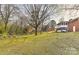 A wide angle view of a home and yard with bare trees in the background at 1235 Robinhood Cir, Charlotte, NC 28227