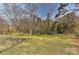 Expansive grassy backyard bordered by trees and fencing at 1235 Robinhood Cir, Charlotte, NC 28227