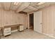 This room in the basement features paneled walls, a desk, and tile floors at 1235 Robinhood Cir, Charlotte, NC 28227