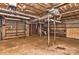 A spacious unfinished basement with utilities, shelving, and support beams at 1235 Robinhood Cir, Charlotte, NC 28227