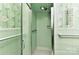 Bathroom featuring green tiles, a shower, and coordinating fixtures for a clean and vintage aesthetic at 1235 Robinhood Cir, Charlotte, NC 28227