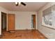 Bedroom with hardwood floors, ceiling fan, and an ensuite bathroom, offering comfort and convenience at 1235 Robinhood Cir, Charlotte, NC 28227