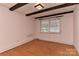 Bedroom showcasing hardwood floors, neutral walls, and natural light from a single window at 1235 Robinhood Cir, Charlotte, NC 28227