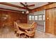 Traditional dining room featuring wood paneling, a ceiling fan, and a view to the outdoors at 1235 Robinhood Cir, Charlotte, NC 28227