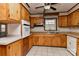Traditional kitchen featuring white appliances, wood cabinets, and a window over the sink at 1235 Robinhood Cir, Charlotte, NC 28227