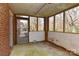 Enclosed sunroom with large windows offering views of the surrounding yard and allowing ample natural light at 1235 Robinhood Cir, Charlotte, NC 28227