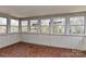 Bright sunroom with multiple windows providing natural light and a unique red mosaic tile floor at 1235 Robinhood Cir, Charlotte, NC 28227