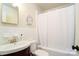 Cozy bathroom with a combination tub and shower, vanity, and a classic white color scheme at 1239 Reece Rd, Charlotte, NC 28209