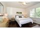 Well-lit bedroom with hardwood floors, soft bedding, and minimalist decor, creating a calming atmosphere at 1239 Reece Rd, Charlotte, NC 28209
