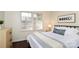 Bright bedroom featuring hardwood floors, white walls, and large windows, creating a serene and inviting space at 1239 Reece Rd, Charlotte, NC 28209