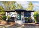 Charming brick home with landscaped front yard, green door, black trim, inviting front porch, and freshly painted white brick at 1239 Reece Rd, Charlotte, NC 28209