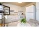 Kitchen features white cabinets, modern appliances, and a cozy breakfast nook at 1239 Reece Rd, Charlotte, NC 28209