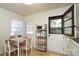 Bright kitchen with a dining table, updated appliances, and lots of natural light from the windows at 1239 Reece Rd, Charlotte, NC 28209