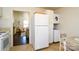 Kitchen includes a large refrigerator, laundry area, and view to the living room at 1239 Reece Rd, Charlotte, NC 28209