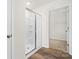Bathroom featuring glass enclosed shower and access to walk-in closet at 124 Rustling Waters Dr, Mooresville, NC 28117