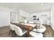 Dining area featuring a wooden table and chairs, modern decor, and an open view of the kitchen at 124 Rustling Waters Dr, Mooresville, NC 28117