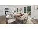 Dining area featuring a wooden table and chairs, modern decor, and an open view of the kitchen at 124 Rustling Waters Dr, Mooresville, NC 28117