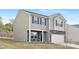 Charming two-story home featuring stone accents, gray siding, and a well-maintained lawn at 124 Rustling Waters Dr, Mooresville, NC 28117