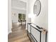 Inviting hallway with sleek console table, stylish mirror, and a glimpse into the bright dining area at 124 Rustling Waters Dr, Mooresville, NC 28117
