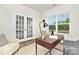 Inviting office featuring a modern desk, window with a view, and stylish French doors at 124 Rustling Waters Dr, Mooresville, NC 28117