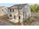 Two-story home featuring gray siding, a concrete patio, and glass patio doors to the backyard at 124 Rustling Waters Dr, Mooresville, NC 28117