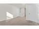 Spacious room featuring neutral carpeting, a bright, airy atmosphere and multiple doors at 124 Rustling Waters Dr, Mooresville, NC 28117