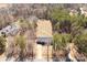 An aerial view of a home showing the driveway, large backyard, and surrounding trees at 13030 Homewood Dr # 12, Charlotte, NC 28262