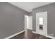 Spacious bedroom featuring modern wood flooring, neutral walls, and bright white door and trim at 13030 Homewood Dr # 12, Charlotte, NC 28262