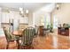 Sunlit breakfast nook with hardwood floors, stainless steel fridge, and a bar area at 13122 Long Common Pkwy, Huntersville, NC 28078