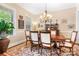 Cozy dining area with chandelier, large window, and view to the lush green yard at 13122 Long Common Pkwy, Huntersville, NC 28078