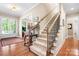 Elegant foyer with hardwood floors, staircase, and an abundance of natural light at 13122 Long Common Pkwy, Huntersville, NC 28078