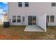 Backyard patio with the home's windows and sliding glass door at 136 S Bell Ave, Albemarle, NC 28001
