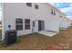 Backyard patio with the home's windows and sliding glass door at 136 S Bell Ave, Albemarle, NC 28001