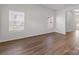 Sunlit bedroom showcasing wood-look floors, neutral walls, and large windows for ample natural light at 136 S Bell Ave, Albemarle, NC 28001