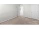 A simple, empty bedroom with a door to the hallway and room for a bed and dresser at 136 S Bell Ave, Albemarle, NC 28001