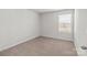 A simple, empty bedroom with a window provides a blank canvas for personalization at 136 S Bell Ave, Albemarle, NC 28001