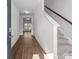 Bright entryway featuring wood-look floors, a staircase, and a view into the living area at 136 S Bell Ave, Albemarle, NC 28001