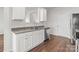 Bright kitchen features white cabinets, granite countertops, and stainless steel dishwasher at 136 S Bell Ave, Albemarle, NC 28001