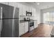 Modern kitchen features stainless steel appliances and white cabinets at 136 S Bell Ave, Albemarle, NC 28001