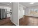 Bright living room with stainless steel refrigerator and hardwood floors at 136 S Bell Ave, Albemarle, NC 28001