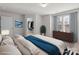This main bedroom features a walk-in closet, a large window with blinds and curtains, and neutral decor at 136 S Bell Ave, Albemarle, NC 28001